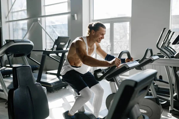 Depositphotos 652500744 stock photo healthy smiling sportsman using elliptical